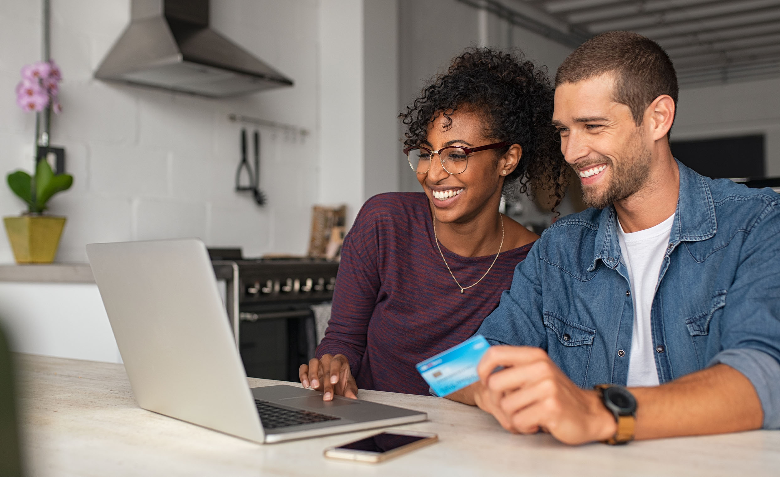Cheerful sales woman showing a design on tablet to mid adult couple looking for furniture at a home store Cheerful sales woman showing a design on tablet to mid adult couple looking for furniture at a home store