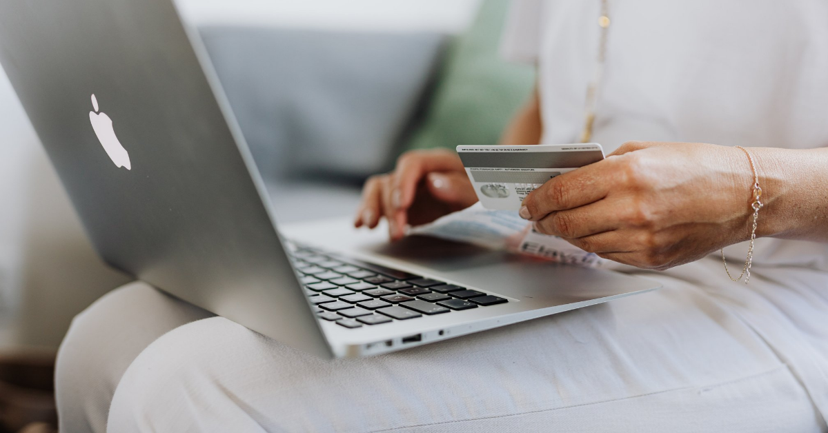 Online Shopping someone using a credit card to purchase something on their laptop